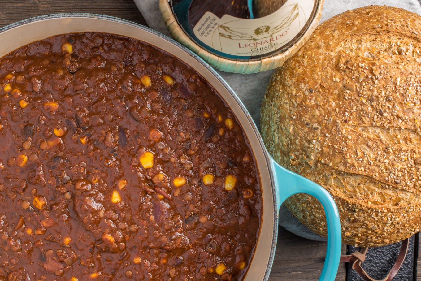 vegan mexican chili in pot with loaf of bread next to it