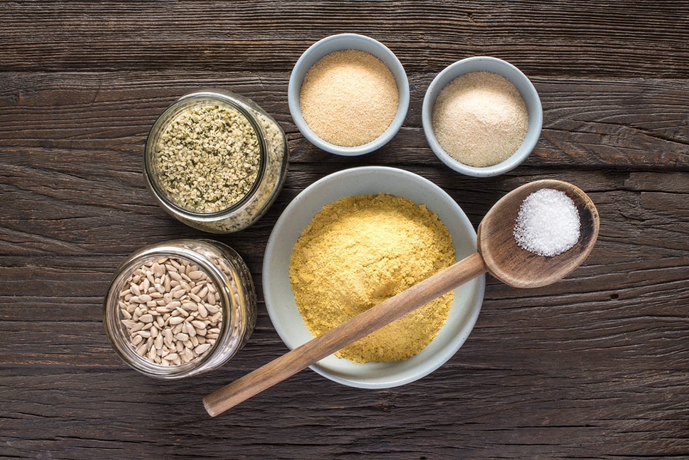 vegan parmesan cheese ingredients in jars and bowls