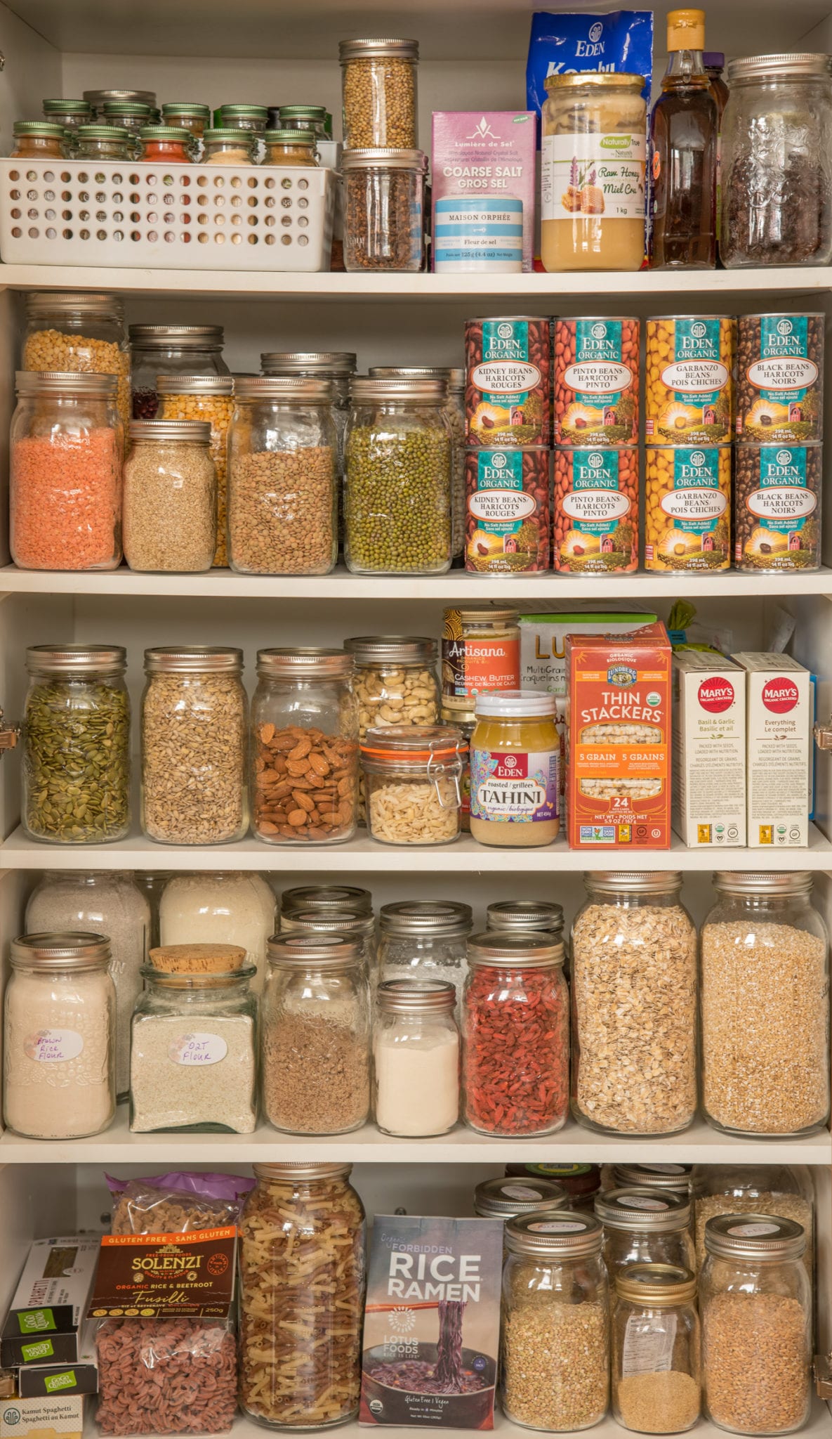 pantry stocked with plant-based items in jars boxes and cans