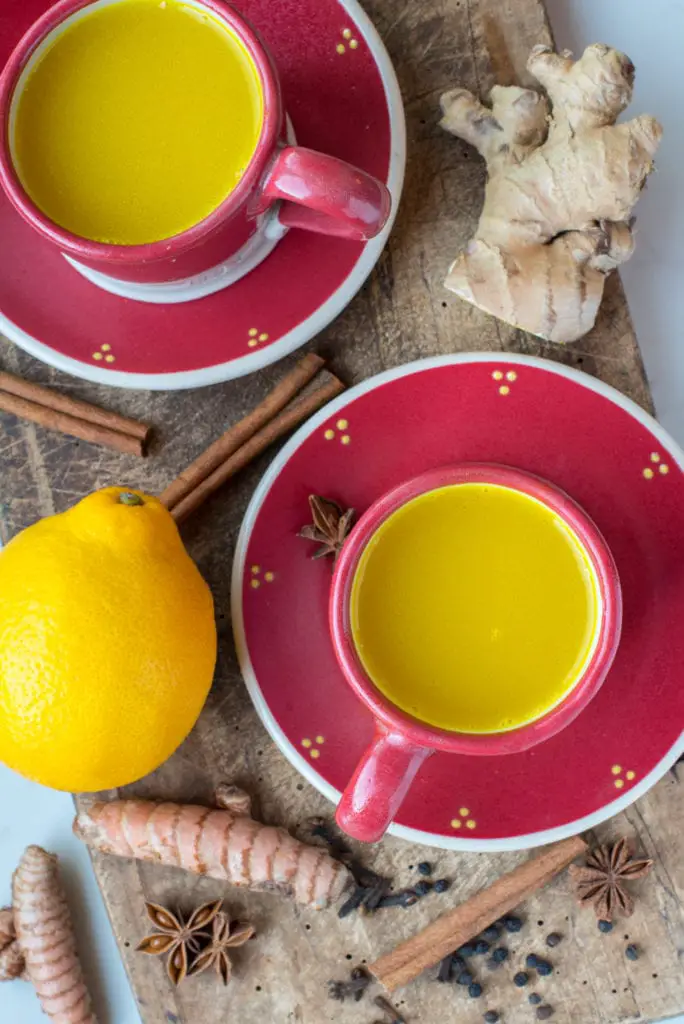 detoxification tea in mugs on cutting board