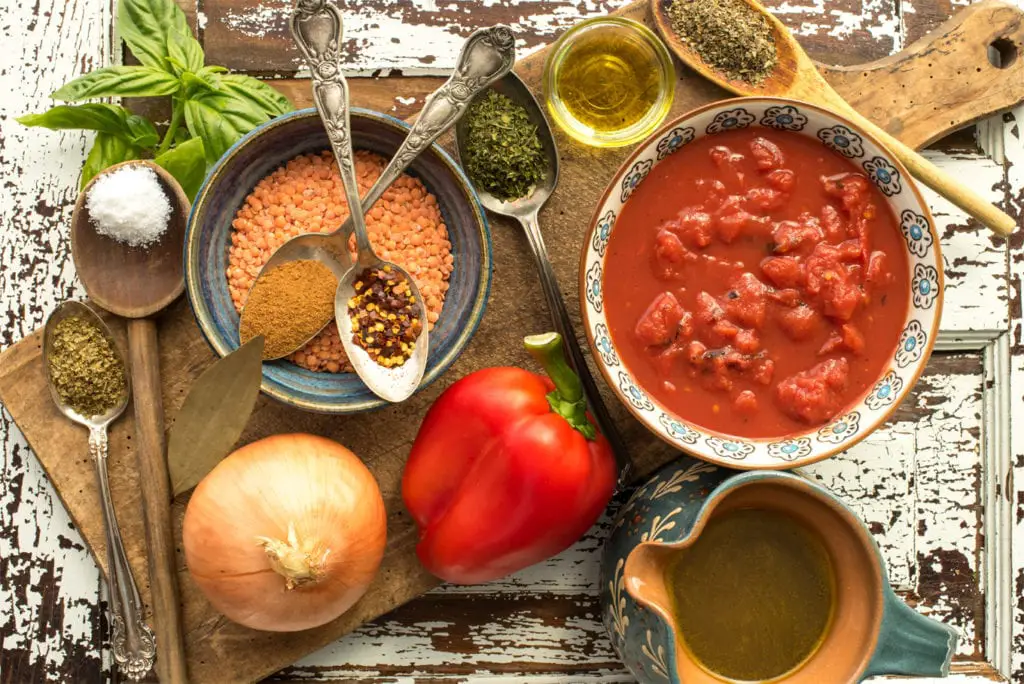 recipe ingredients in bowls and on spoons on cutting board