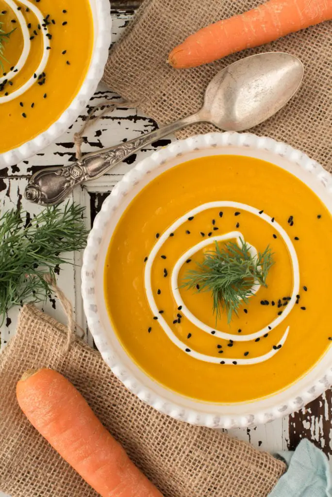 warming carrot ginger soup in two bowls