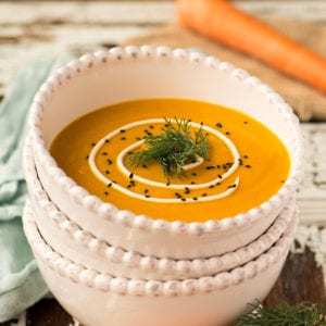 warming in carrot ginger soup in bowl