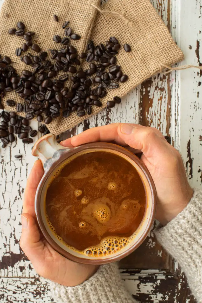 superfood coffee in cup held by hands