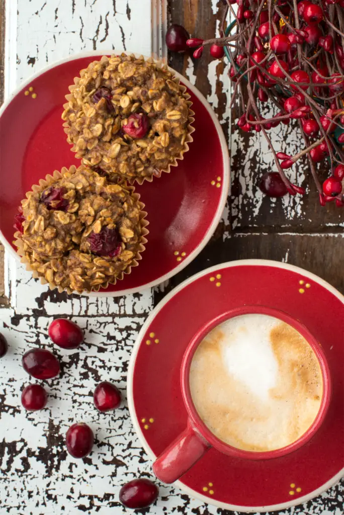 oatmeal cranberry muffins on plate next to latte