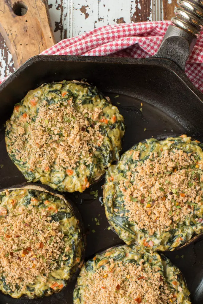 spinach stuffed portobello mushrooms in skillet