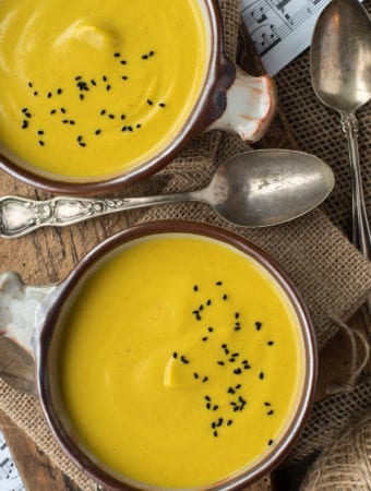 anti-inflammatory cauliflower soup in bowls on cutting board