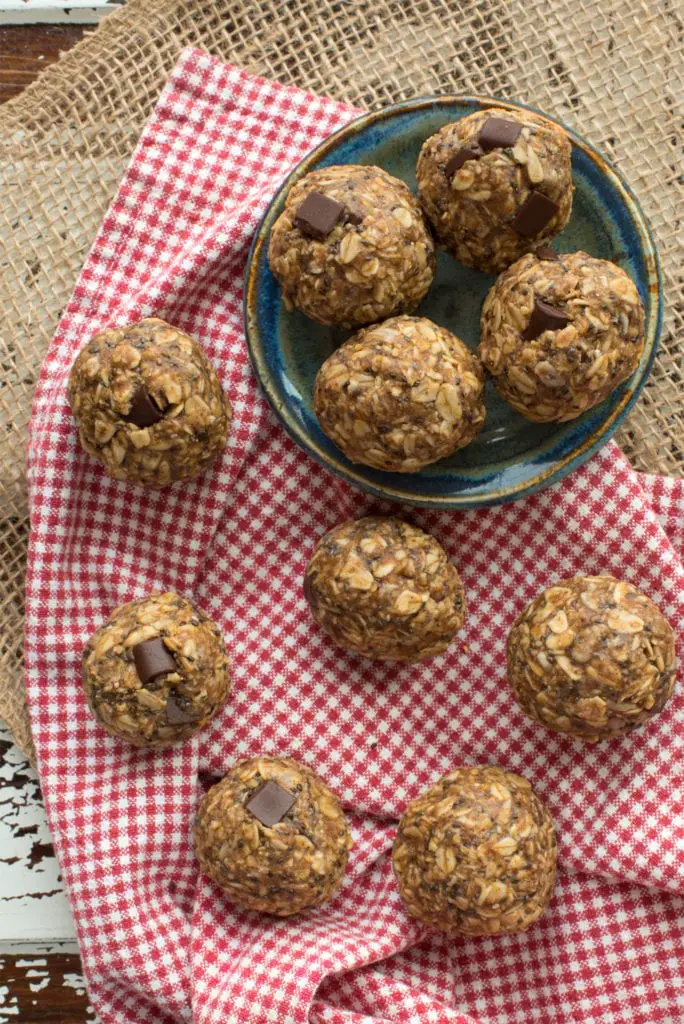 seedy almond butter energy bites on plate and checked cloth