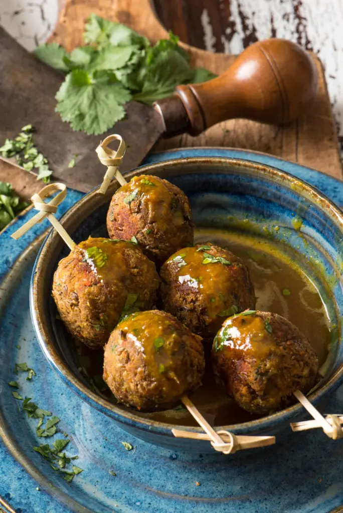 asian lentil balls on skewers in bowl