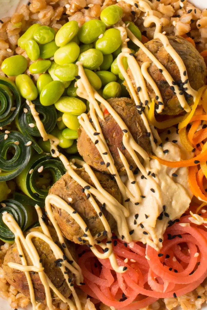 asian lentil balls with pickled veg edamame cucumber and hummus