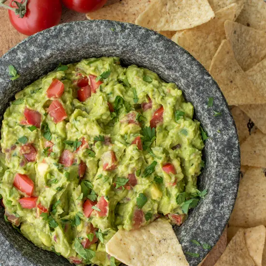homemade guacamole in molcajete with tortilla chips