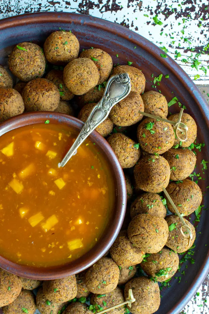 pineapple sweet and sour sauce with lentil balls on platter