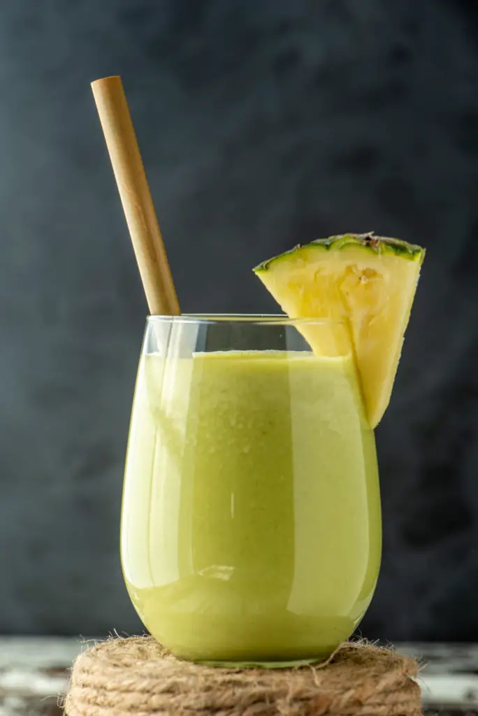 refreshing pineapple salsa smoothie in glass on roll of twine