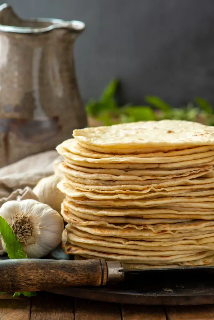 homemade flore tortillas stacked on pizza stone