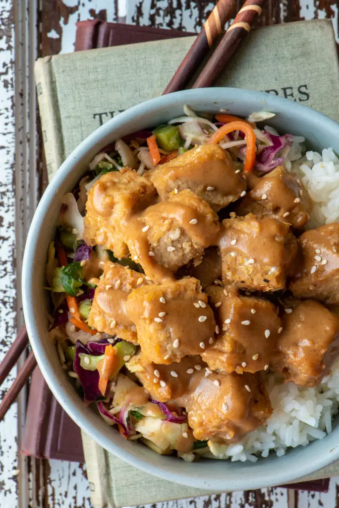 miso baked tempeh in bowl on top of books