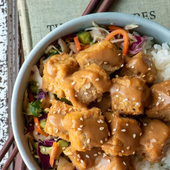 miso baked tempeh with rice and slaw in bowl