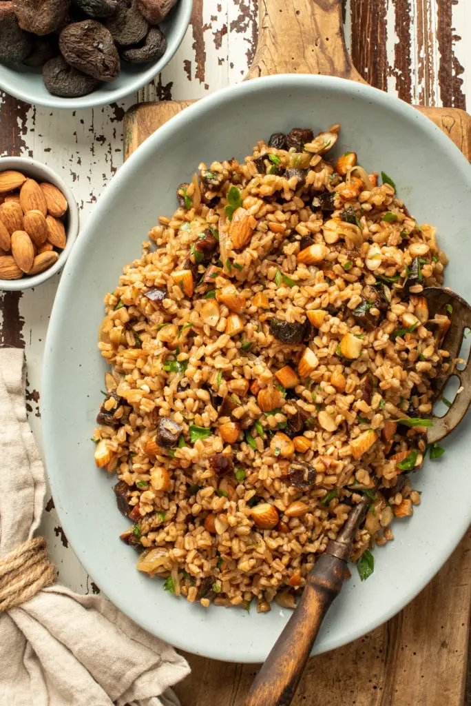 wholesome and healthy farro salad on platter sitting on cutting board