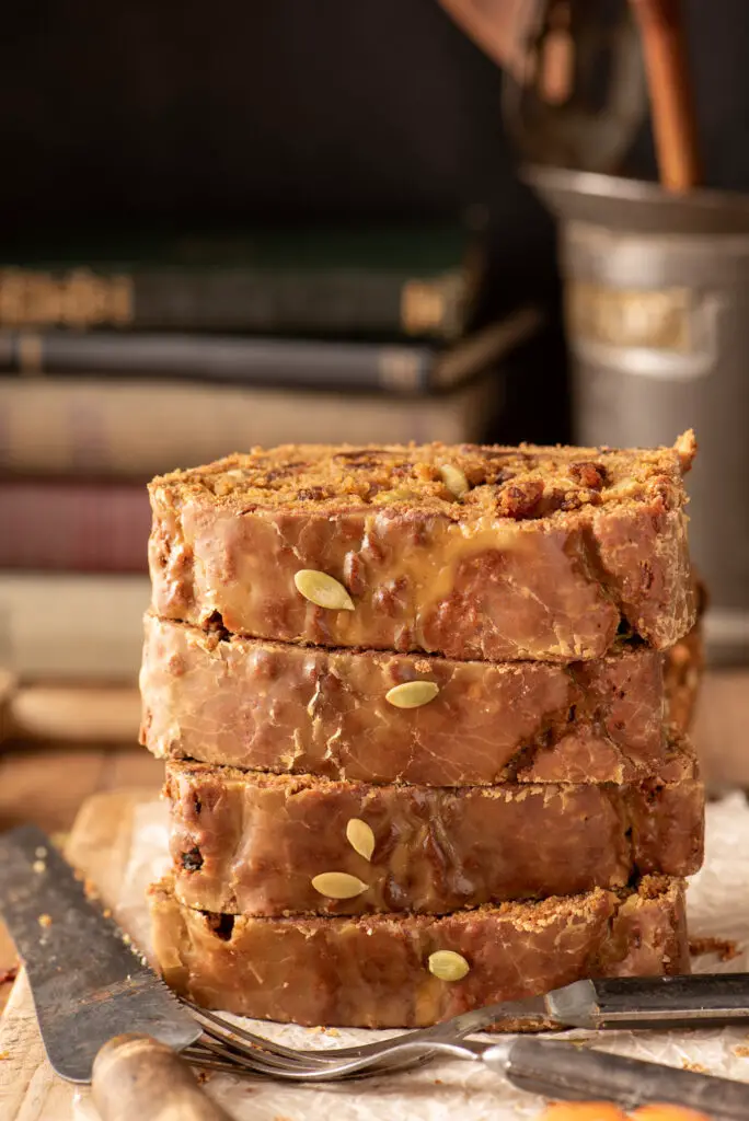 stacked slices of maple cinnamon glazed pumpkin loaf