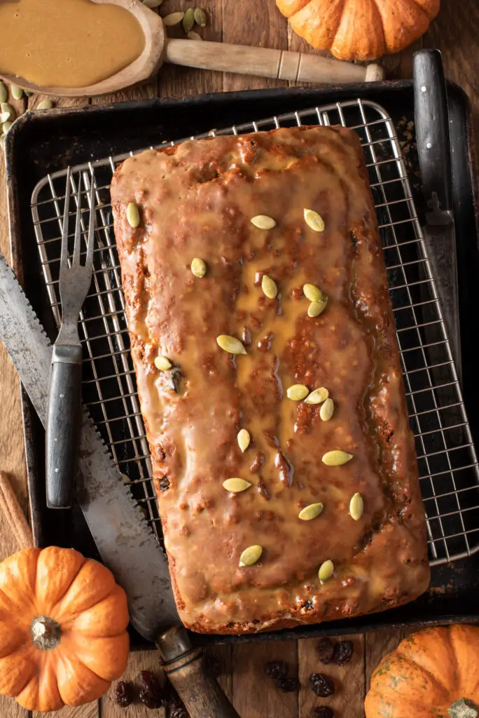 maple cinnamon glazed pumpkin loaf on cooling rack