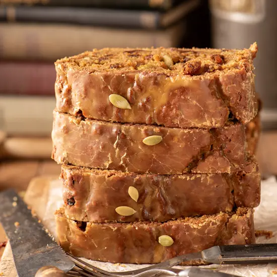 stacked slices of maple cinnamon glazed pumpkin loaf