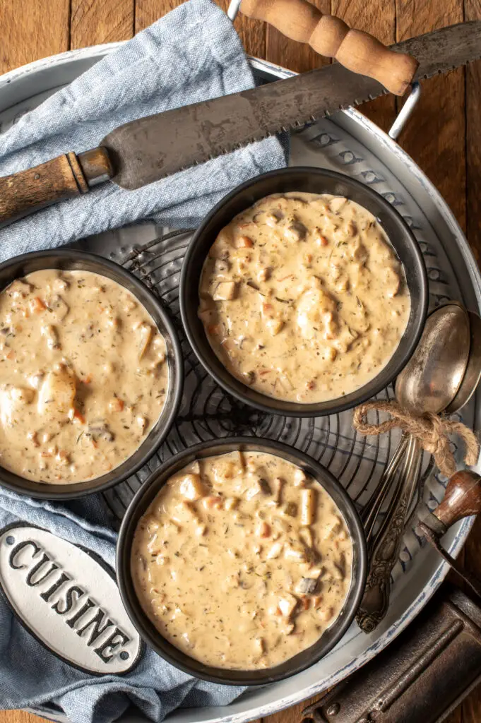 vegan clam chowder in three bowls