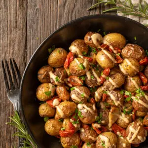 roasted potatoes and tomatoes in serving dish - foodgawker image
