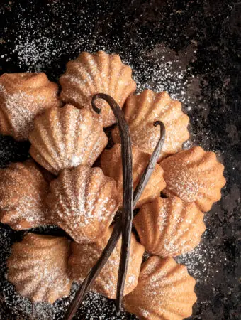 vegan french petites madeleines on baking sheet with vanilla pods