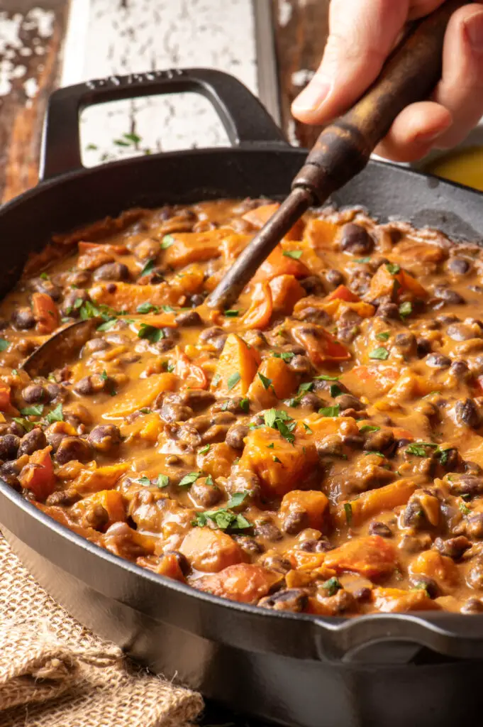 black bean and sweet potato stew in iron skillet