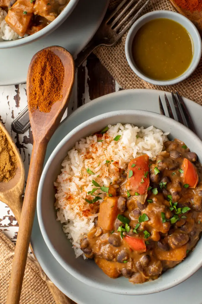 black bean and sweet potato stew with rice in pottery bowl