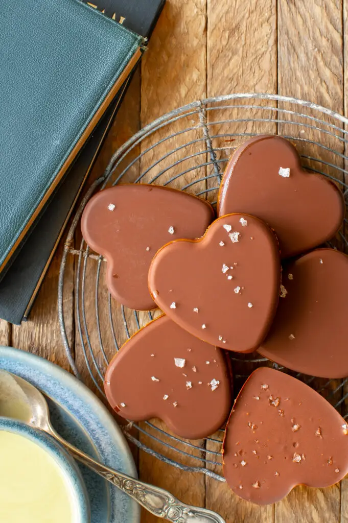 simple almond butter cups on cooling rack next to books and match tea in cup