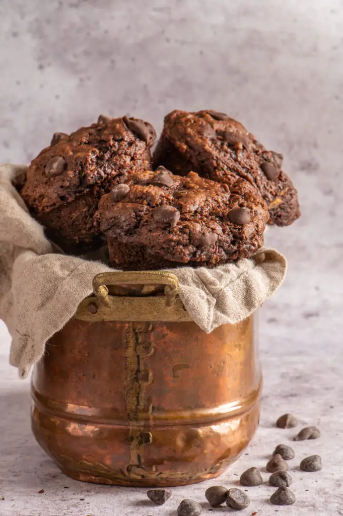 vegan double chocolate zucchini muffins in copper pot