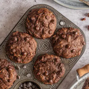 vegan double chocolate zucchini muffins in muffin tin