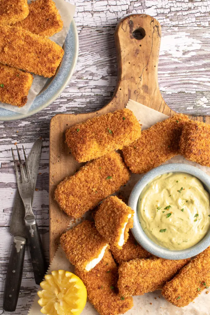 crispy tofu strips on plate next to bowl of spicy cashew avocado mayo