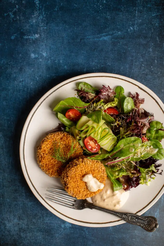 vegan crabless cakes with green salad on plate