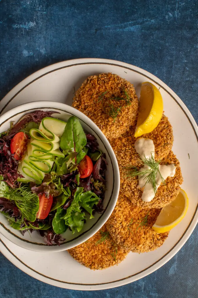 vegan crabless cakes with green salad on plate