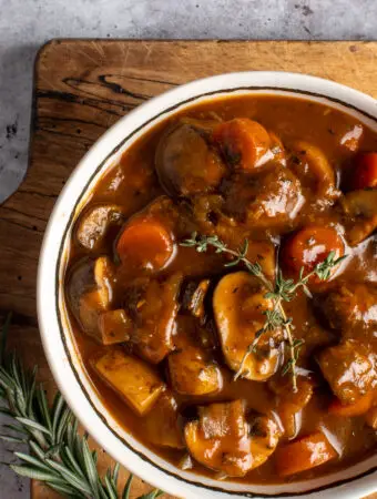 vegan irish guinness stew in bowl on cutting board