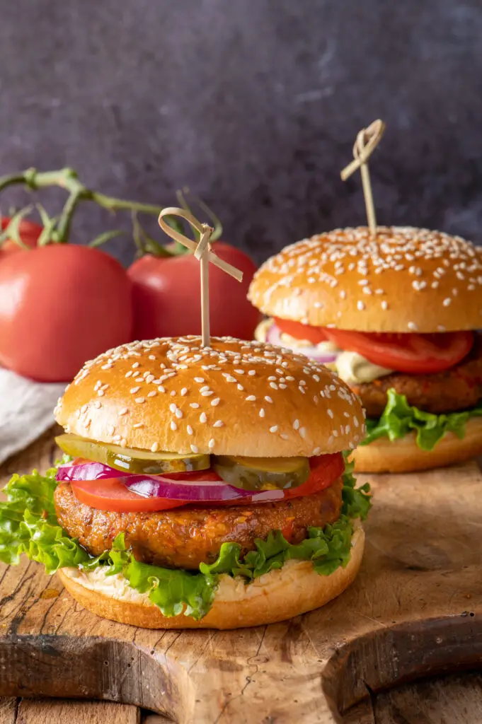 two chickpea veggie burgers on cutting board