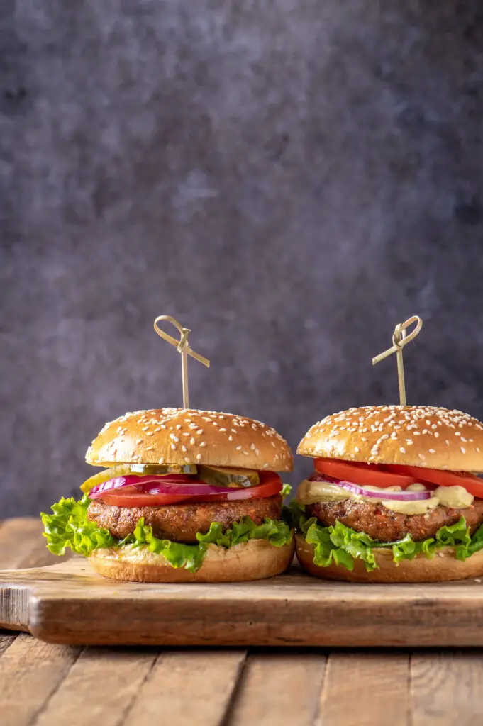 two chickpea veggie burgers on cutting board