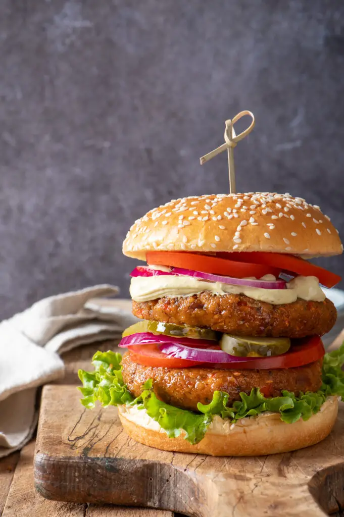 two chickpea veggie patties on bun with condiments