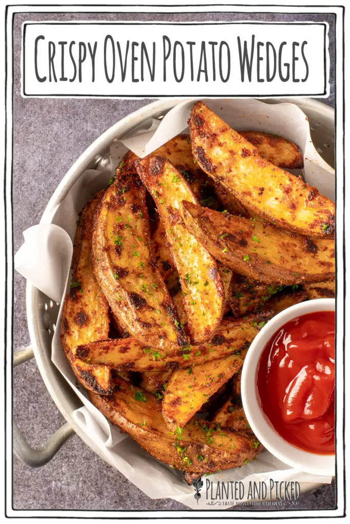 crispy oven potato wedges in colander with small dish of ketchup - pinterest image