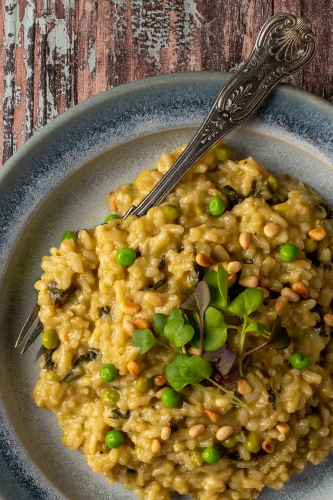 spring pesto risotto on blue pottery plate