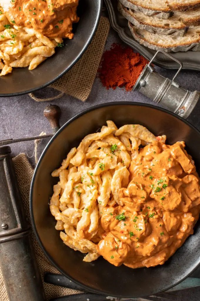 vegan hungarian tofu paprikash in two black bowls