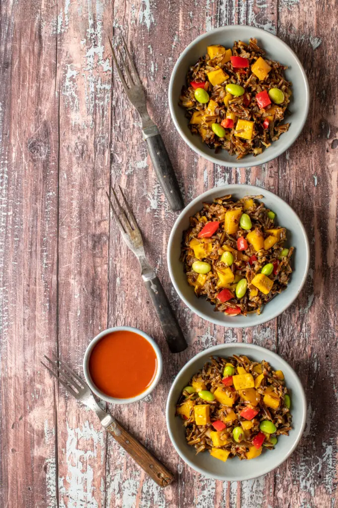 wild rice and mango salad in three small bowls