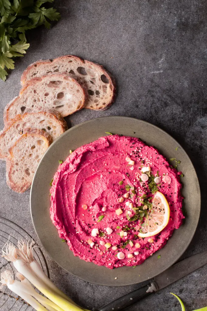 beet and dill hummus on pewter plate