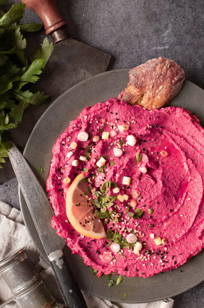beet and dill hummus on pewter plate