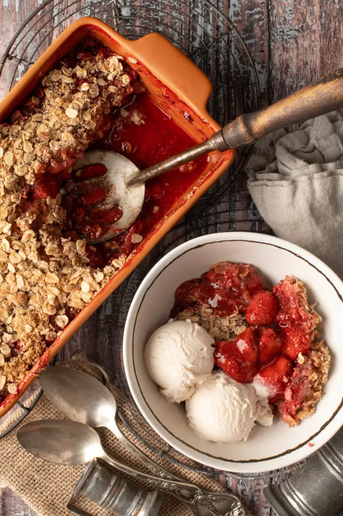 strawberry coconut crumble in bowl next to crumble in baking dish