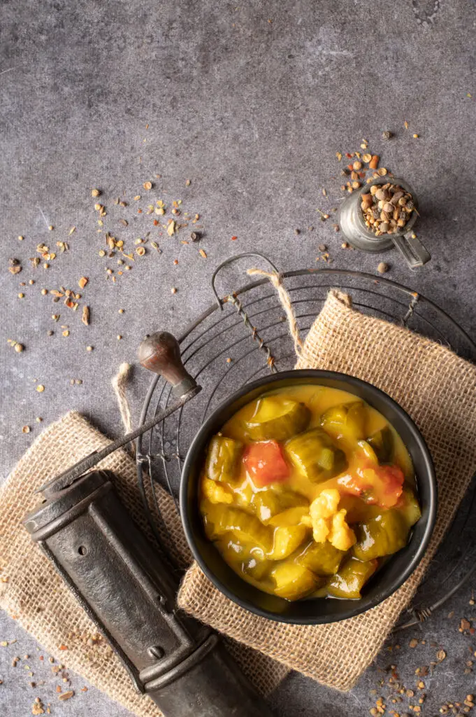 mustard pickles in black bowl sitting on cooling rack