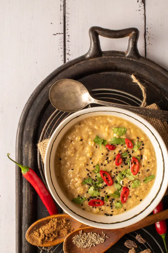 basic mung dal in white bowl sitting on oval cast iron griddle