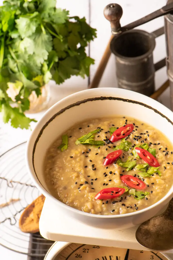 basic mung dal in white bowl sitting on kitchen scale