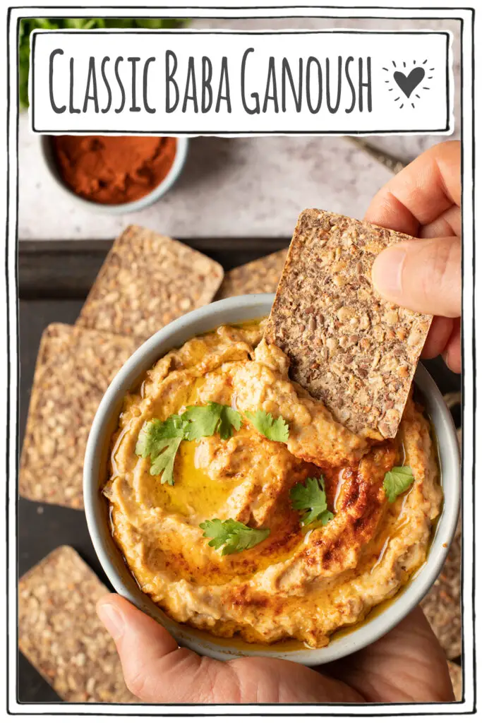 baba ganoush in bowl with hand dipping cracker into bowl - pinterest image